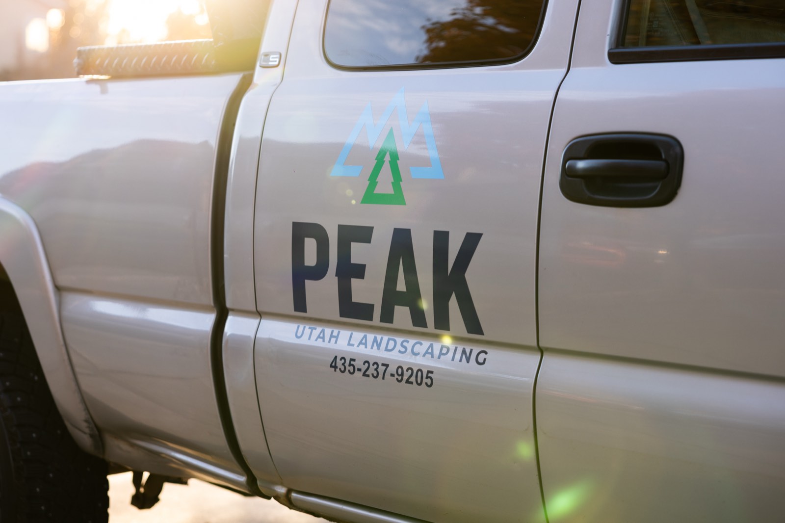 Peak Utah Landscaping truck at sunset